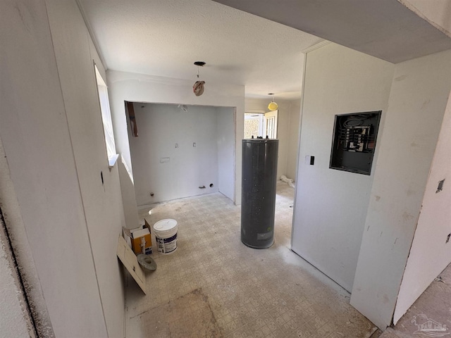 hall featuring water heater, a textured ceiling, and light floors