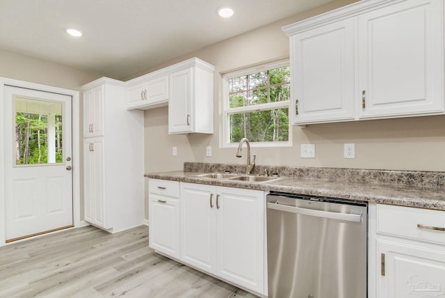 kitchen with white cabinetry, dishwasher, and sink