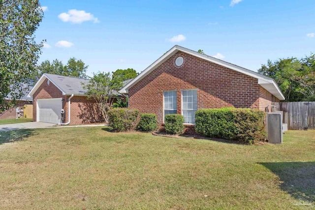 view of property featuring a garage and a front lawn