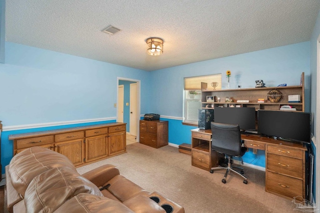 office area featuring light carpet, a textured ceiling, and visible vents