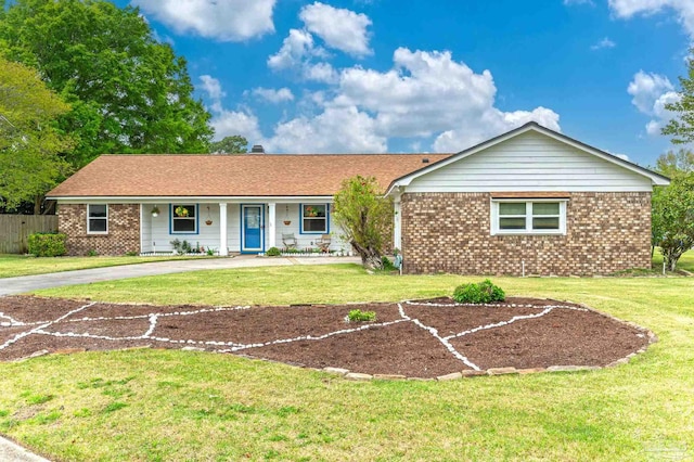 single story home with a front lawn, brick siding, and covered porch