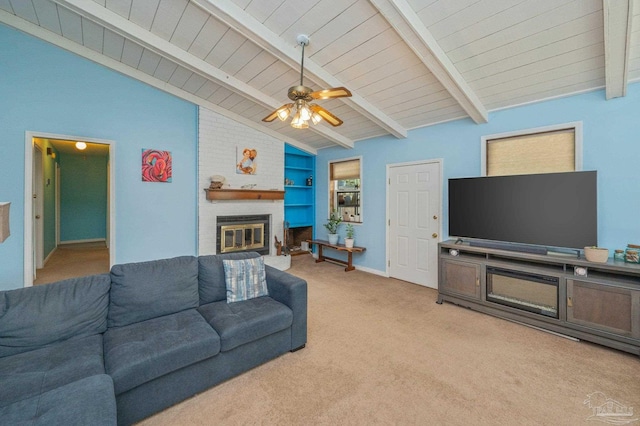 living room featuring lofted ceiling with beams, wood ceiling, ceiling fan, light carpet, and a fireplace