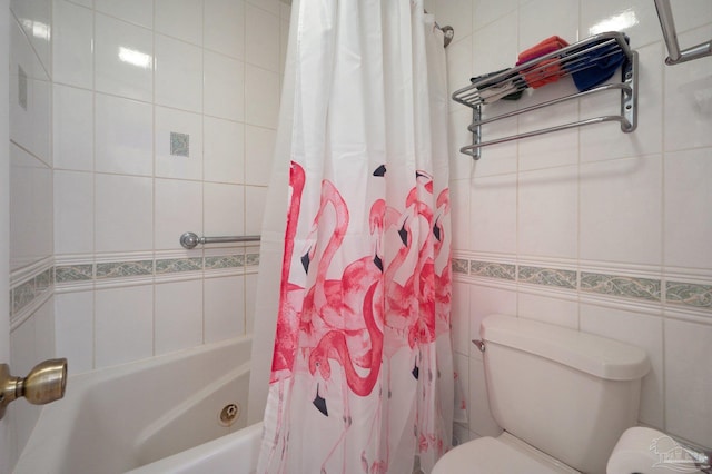 full bathroom with tile walls, shower / tub combo, and toilet