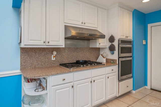 kitchen with stainless steel appliances, white cabinetry, open shelves, under cabinet range hood, and light tile patterned floors