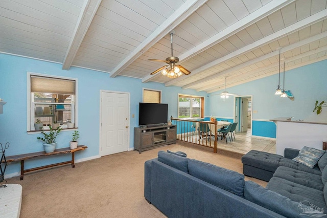 living room featuring lofted ceiling with beams, light carpet, baseboards, a ceiling fan, and wood ceiling