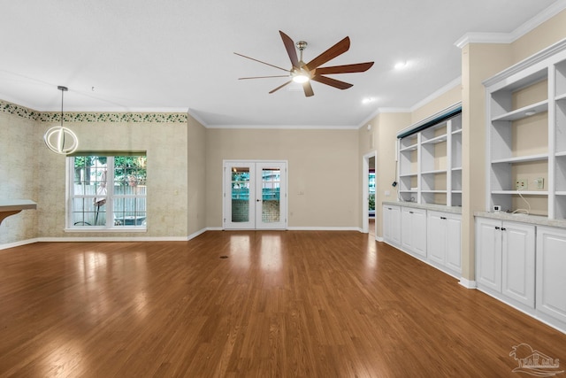 unfurnished living room with crown molding, baseboards, and wood finished floors