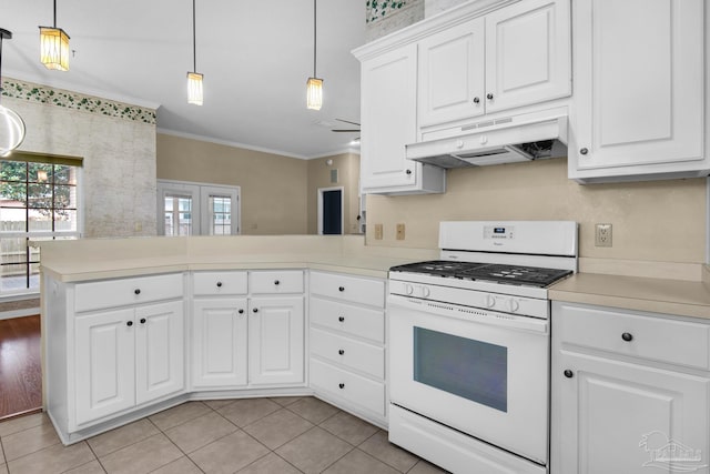 kitchen featuring gas range gas stove, light countertops, ornamental molding, a peninsula, and under cabinet range hood