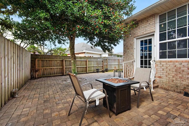 view of patio with a fenced backyard and a fire pit