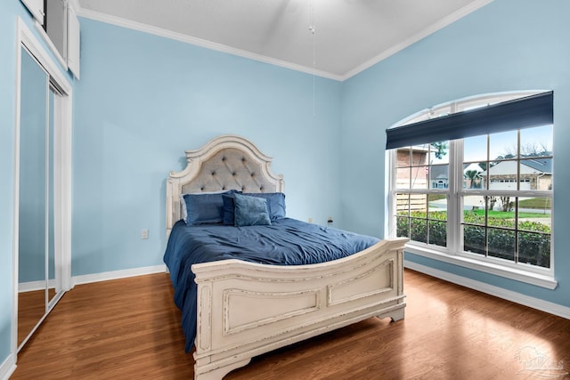 bedroom featuring crown molding, wood finished floors, and baseboards