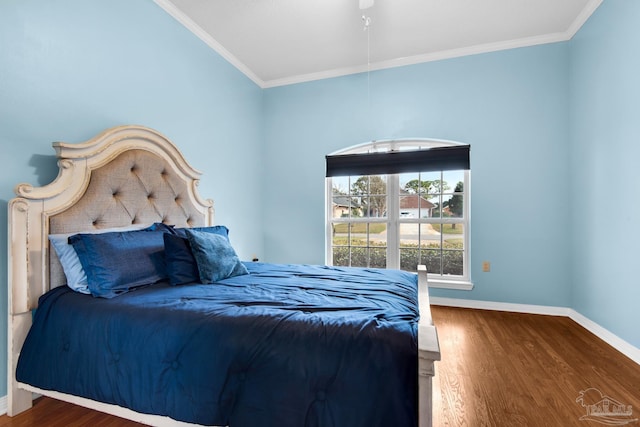 bedroom with ornamental molding, wood finished floors, and baseboards