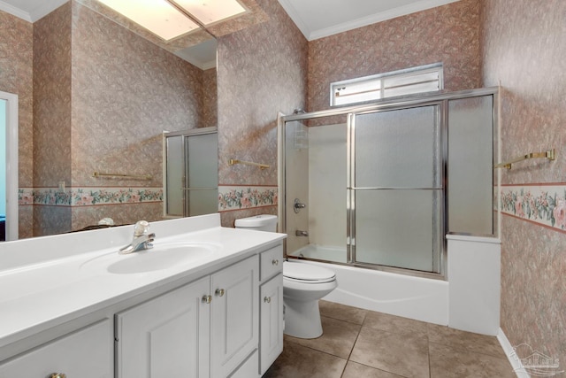 bathroom with wallpapered walls, toilet, ornamental molding, vanity, and tile patterned floors