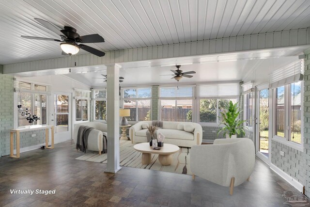 sunroom featuring plenty of natural light and ceiling fan