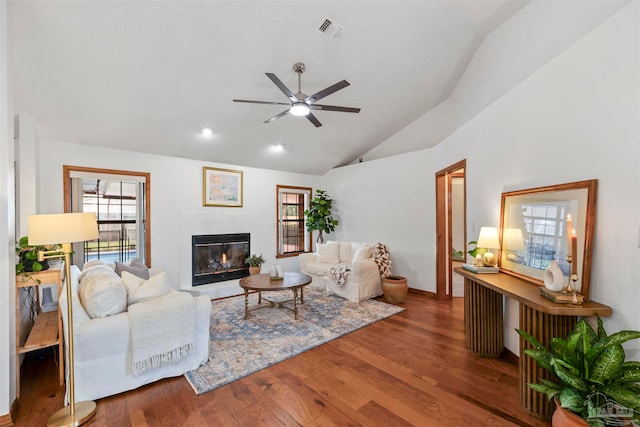 living room with lofted ceiling, ceiling fan, and hardwood / wood-style flooring