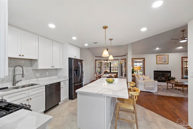 kitchen featuring white cabinetry, ceiling fan, pendant lighting, and stainless steel appliances