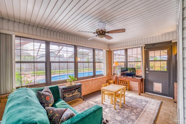 sunroom / solarium featuring ceiling fan and wooden ceiling