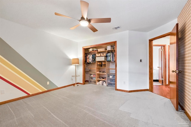 unfurnished room with ceiling fan and carpet flooring