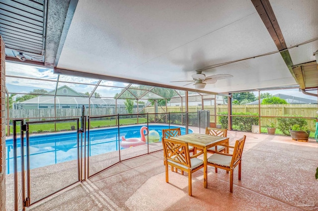 view of swimming pool with a lanai, ceiling fan, and a patio area