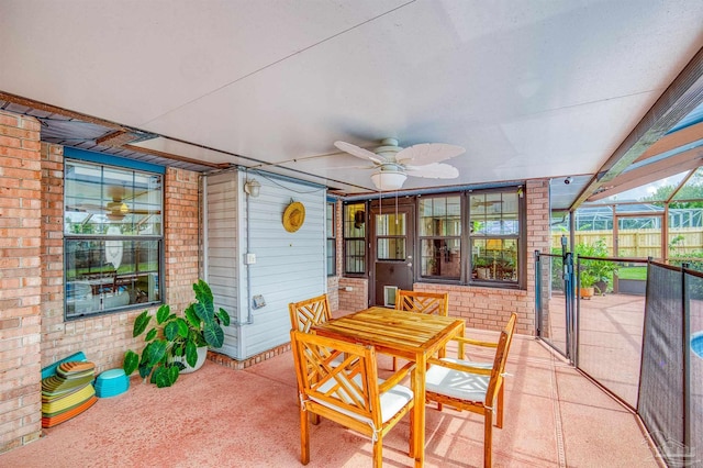 sunroom / solarium featuring ceiling fan