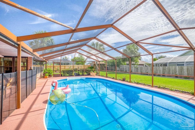 view of pool featuring a yard and a lanai