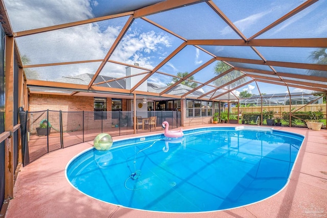 view of swimming pool featuring a lanai and a patio area