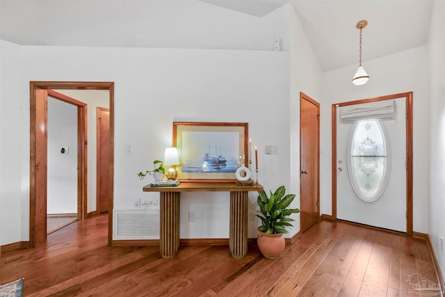 foyer featuring hardwood / wood-style flooring and lofted ceiling