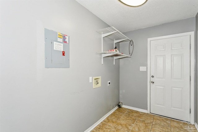 clothes washing area featuring electric dryer hookup, washer hookup, electric panel, and a textured ceiling