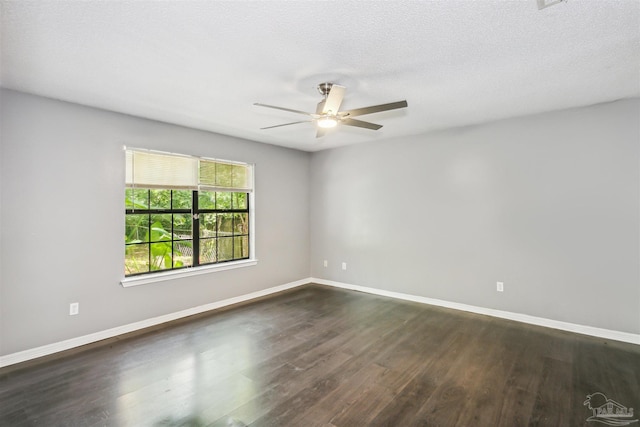 unfurnished room with ceiling fan, dark hardwood / wood-style floors, and a textured ceiling