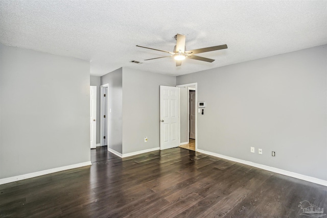 spare room featuring ceiling fan, dark hardwood / wood-style floors, and a textured ceiling