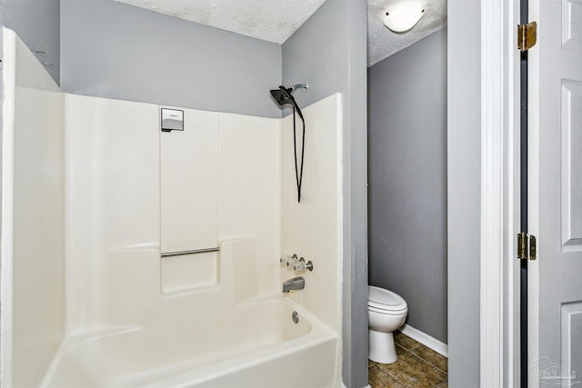 bathroom with shower / tub combination, tile patterned floors, a textured ceiling, and toilet