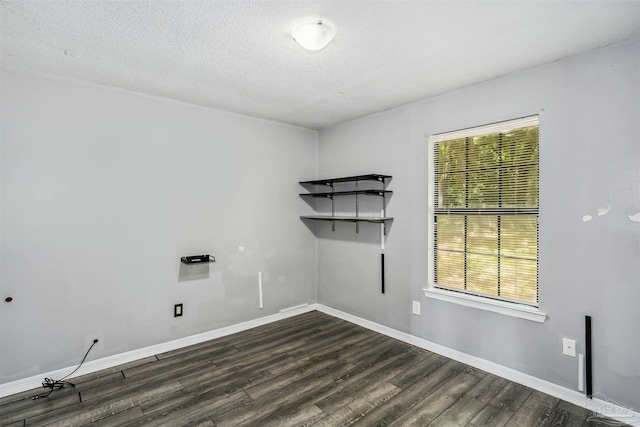 washroom featuring plenty of natural light, dark hardwood / wood-style floors, and a textured ceiling