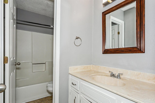 full bathroom featuring toilet, a textured ceiling, vanity, shower / washtub combination, and tile patterned flooring