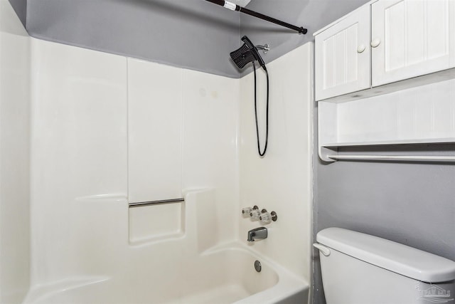 bathroom with toilet and  shower combination