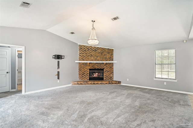 unfurnished living room featuring a fireplace, vaulted ceiling, and carpet