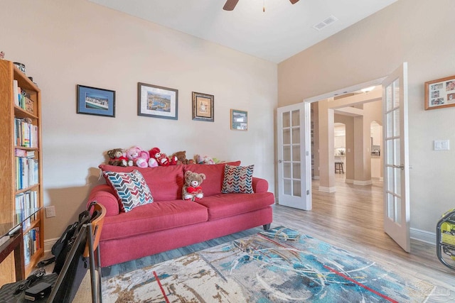 3246 Main St, Navarre, FL 32566 - living area with french doors, visible vents, ceiling fan, wood finished floors, and baseboards