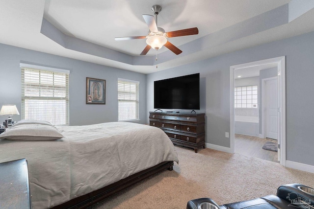 3246 Main St, Navarre, FL 32566 - carpeted bedroom featuring a ceiling fan, a raised ceiling, baseboards, and ensuite bathroom