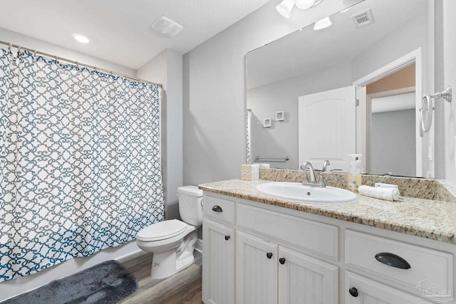 3246 Main St, Navarre, FL 32566 - full bath with toilet, visible vents, wood finished floors, and vanity
