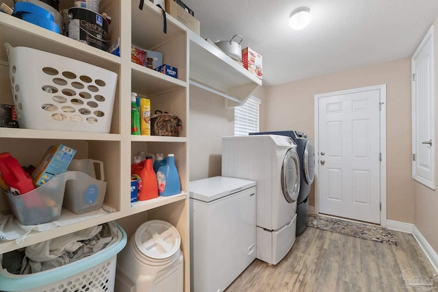 3246 Main St, Navarre, FL 32566 - washroom featuring laundry area, washer and clothes dryer, light wood-style flooring, and baseboards