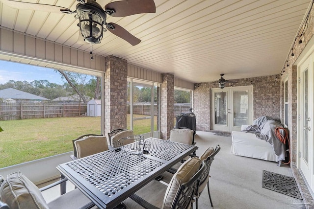 3246 Main St, Navarre, FL 32566 - view of patio / terrace featuring an outbuilding, a fenced backyard, a storage shed, french doors, and outdoor dining space