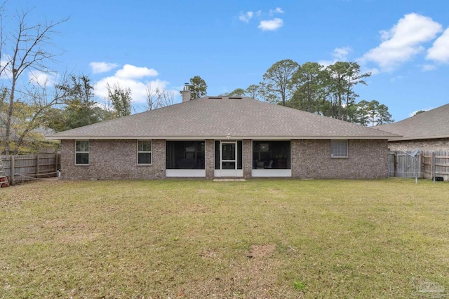 3246 Main St, Navarre, FL 32566 - rear view of property featuring brick siding, a lawn, a chimney, and a fenced backyard