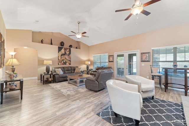 3246 Main St, Navarre, FL 32566 - living room with baseboards, a ceiling fan, french doors, light wood-style floors, and high vaulted ceiling