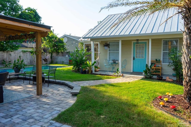 view of yard featuring a fenced in pool, a patio, a porch, and fence