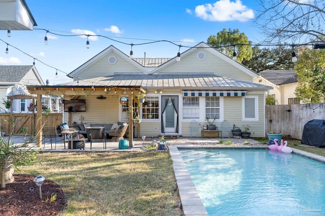 back of house featuring a fenced in pool, metal roof, a patio, and fence