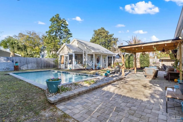 view of swimming pool with a fenced in pool, an exterior structure, a fenced backyard, an outdoor structure, and a patio area