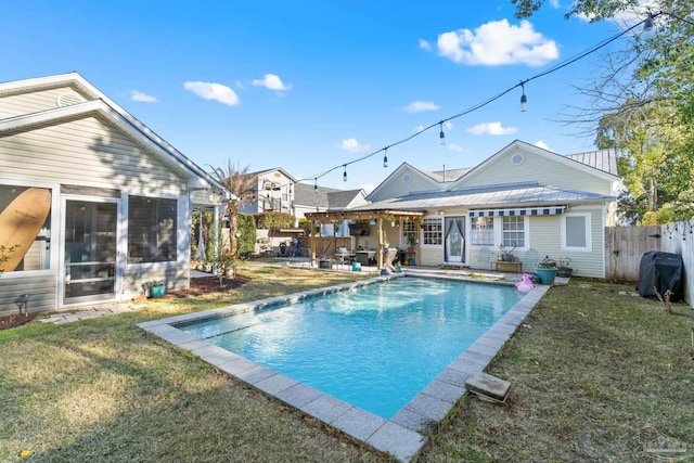 view of swimming pool featuring grilling area, a fenced in pool, fence, a lawn, and a patio area