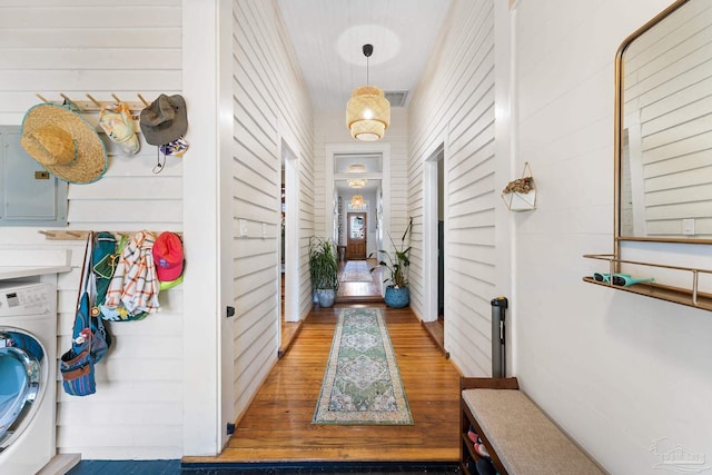 entryway featuring electric panel, visible vents, washer / dryer, and wood finished floors