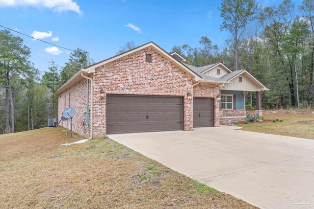 ranch-style home with a garage, driveway, brick siding, central AC unit, and a front yard