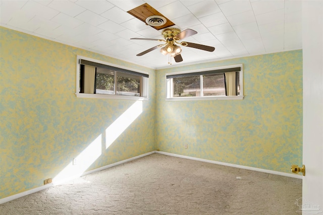 carpeted spare room featuring ceiling fan