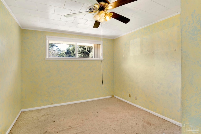 empty room featuring carpet flooring, ceiling fan, and ornamental molding