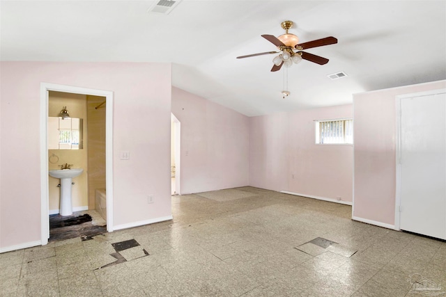 spare room with ceiling fan, plenty of natural light, and vaulted ceiling