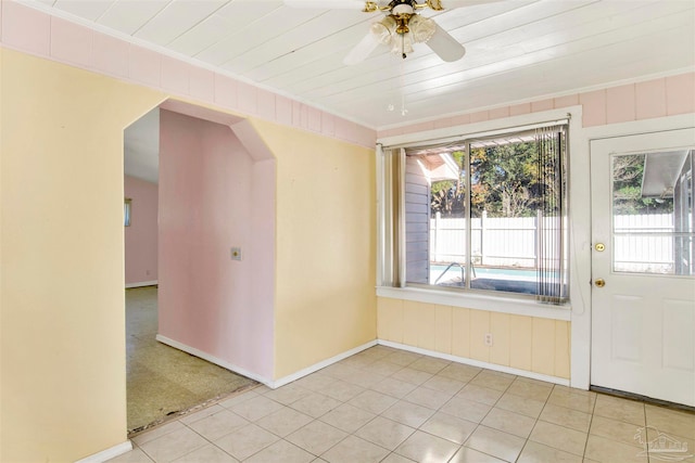 carpeted spare room featuring ceiling fan, wood ceiling, and ornamental molding